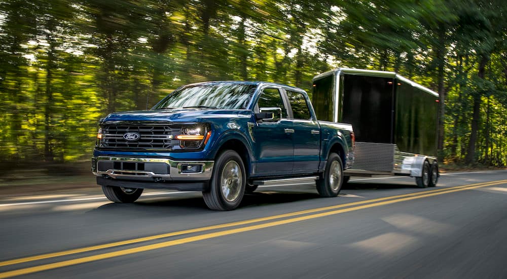 A blue 2025 Ford F-150 from the front at an angle after leaving a Ford dealer.