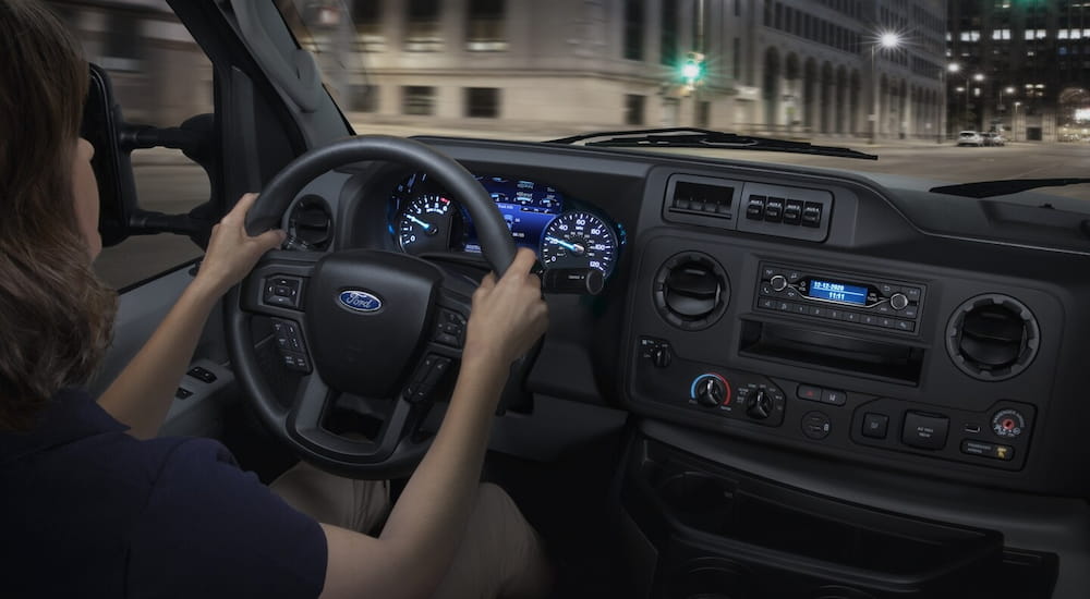 Interior view of a 2026 Ford E-Series Cutaway with a person driving it.