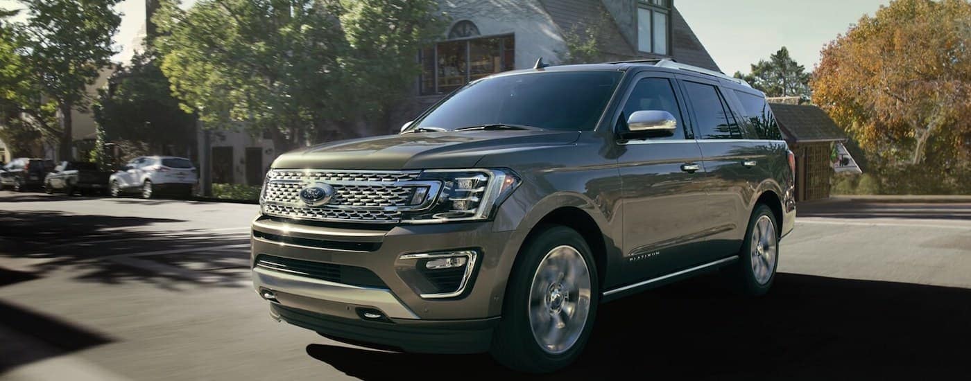 Brown 2020 Ford Expedition driving down an open road.
