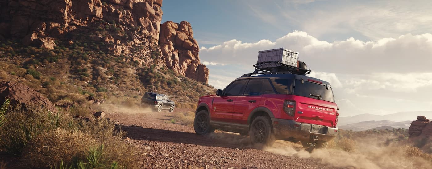 Rear of a red 2026 Ford Bronco Sport driving off-road.