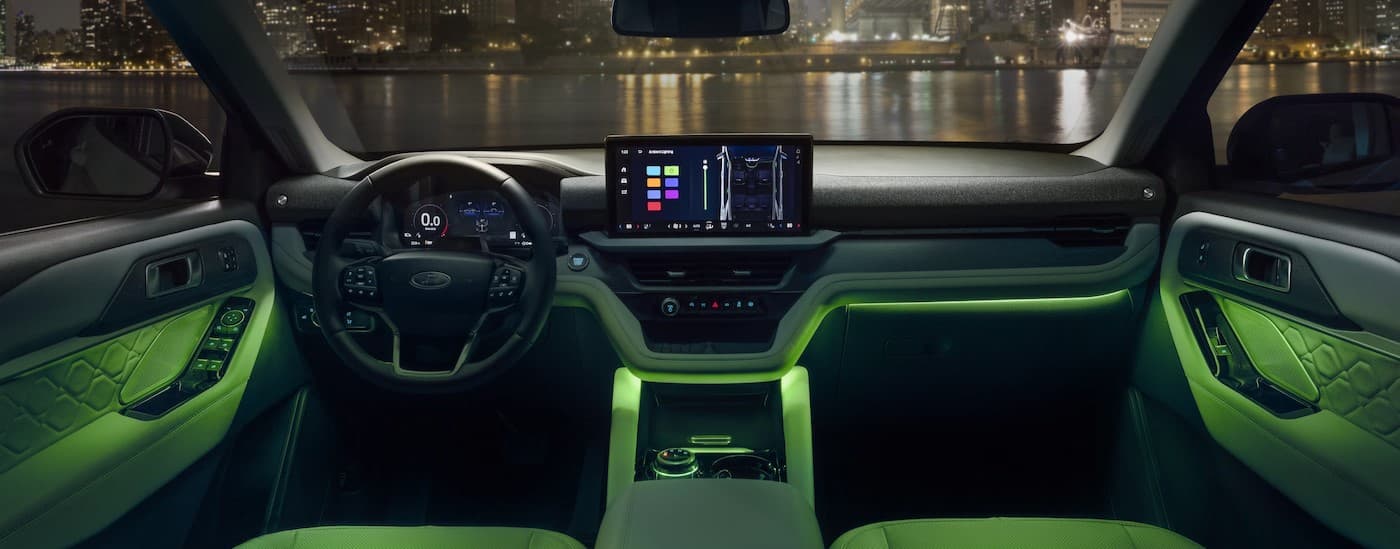 The highlighted green interior in a 2025 Ford Explorer parked at night.