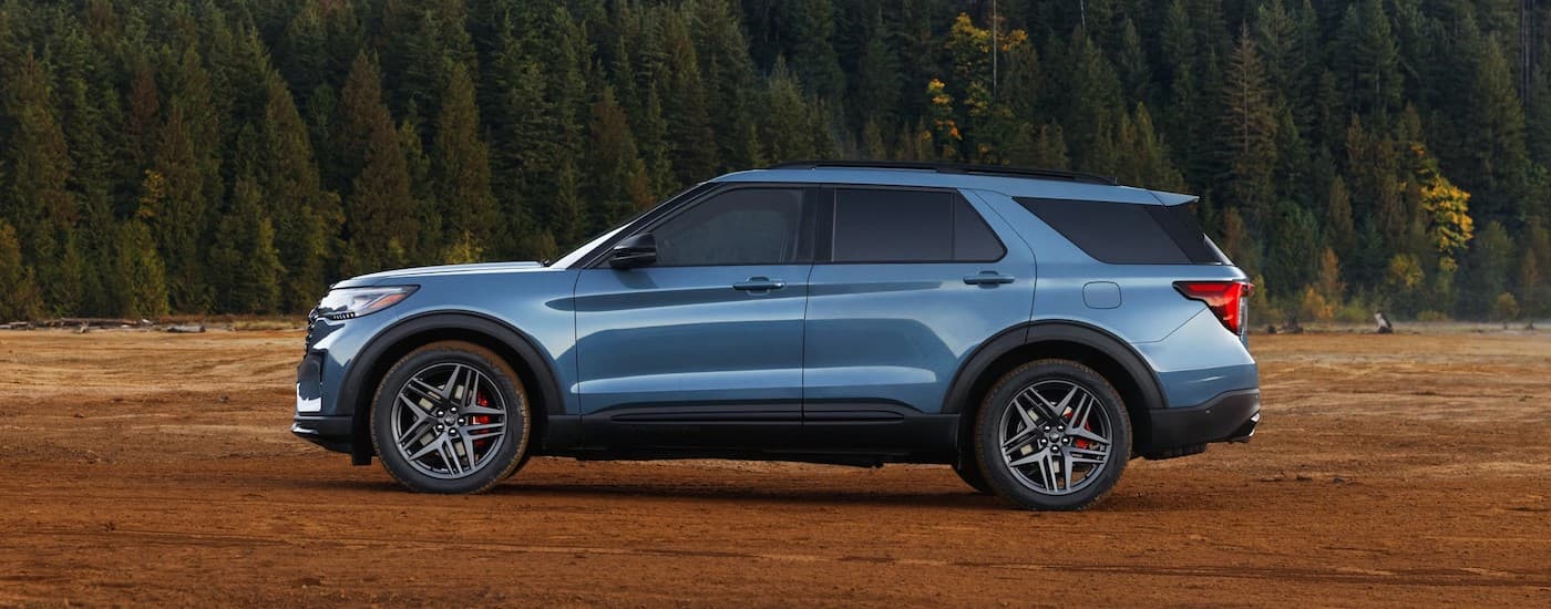 A blue 2025 Ford Explorer parked off-road.
