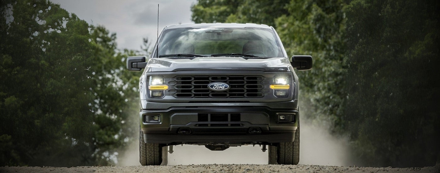 Grey 2026 Ford F-150 Tremor driving down a dusty trail