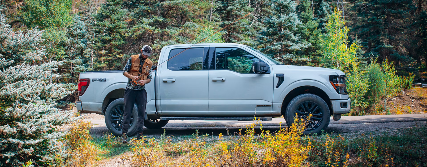 Grey 2026 Ford F-150 Lariat with a fisherman getting his rod