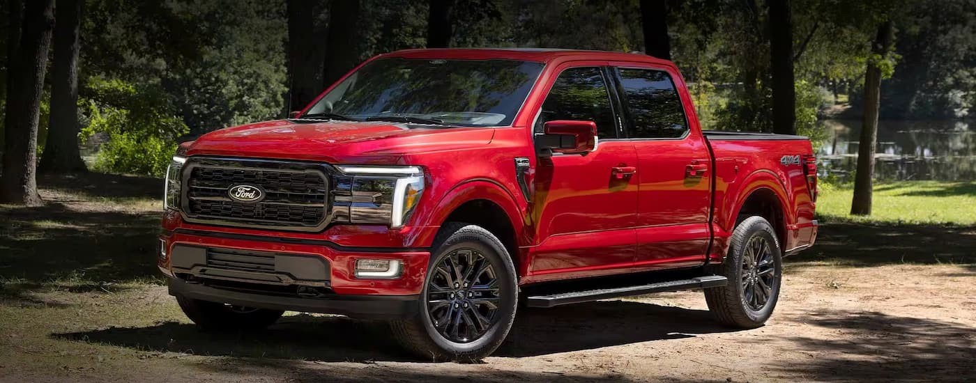 Red 2026 Ford F-150 parked off-road.