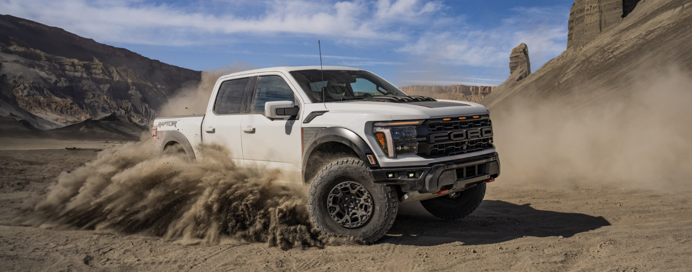 White 2026 Ford F-150 Raptor drifting off-road
