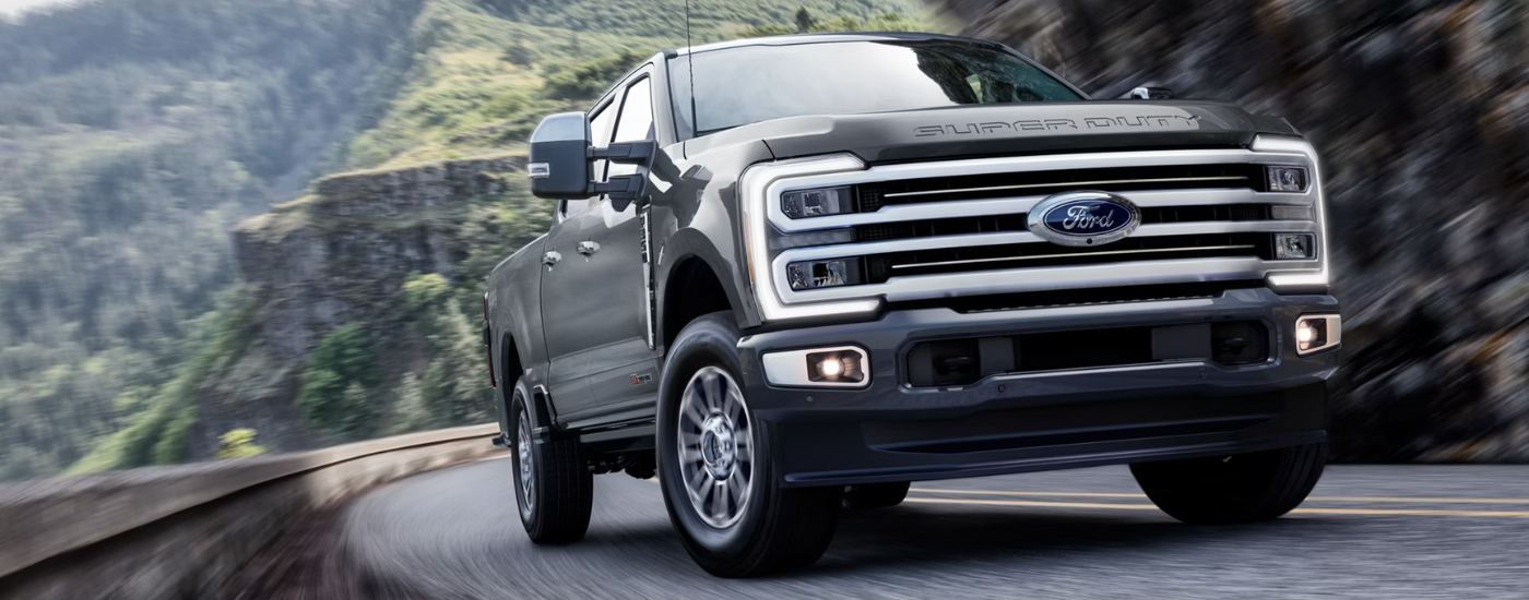 Grey 2026 Ford F-250 SD driving along a cliff