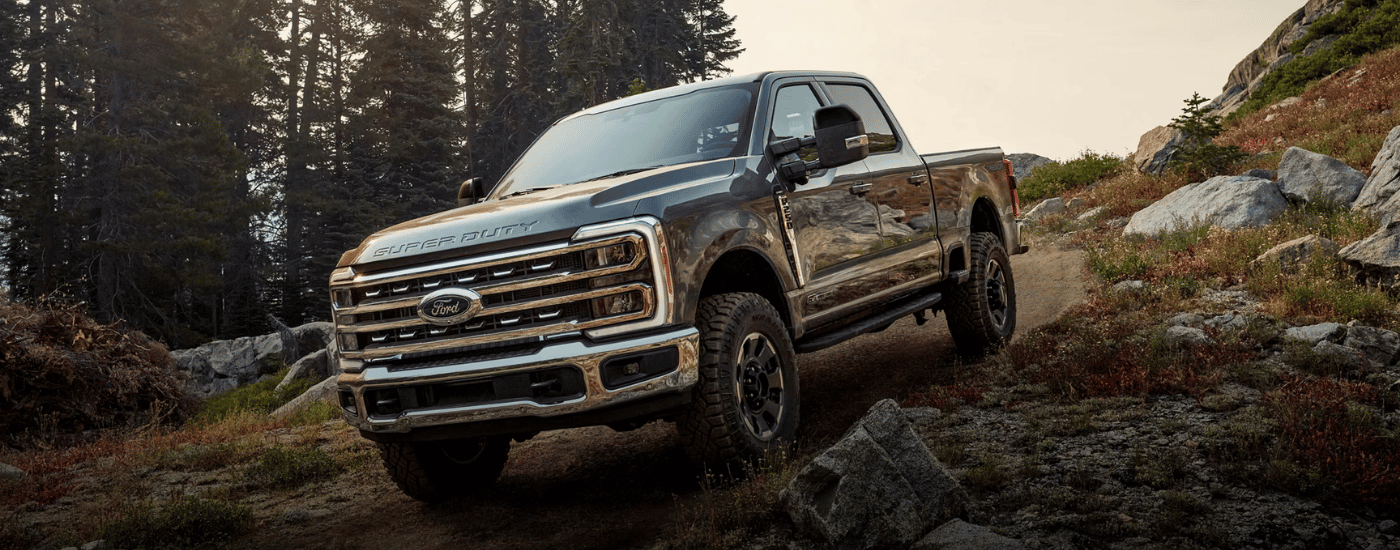 Grey 2026 Ford F-250 SD driving down a hill off-roading