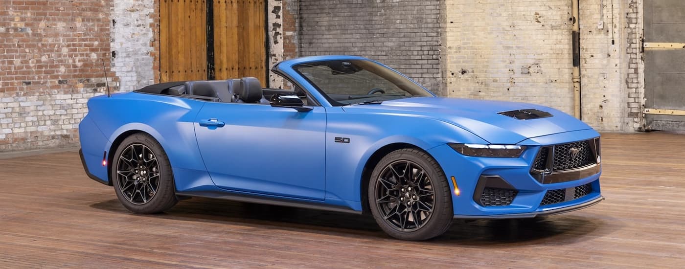 Blue 2026 Ford Mustang parked in a showroom.