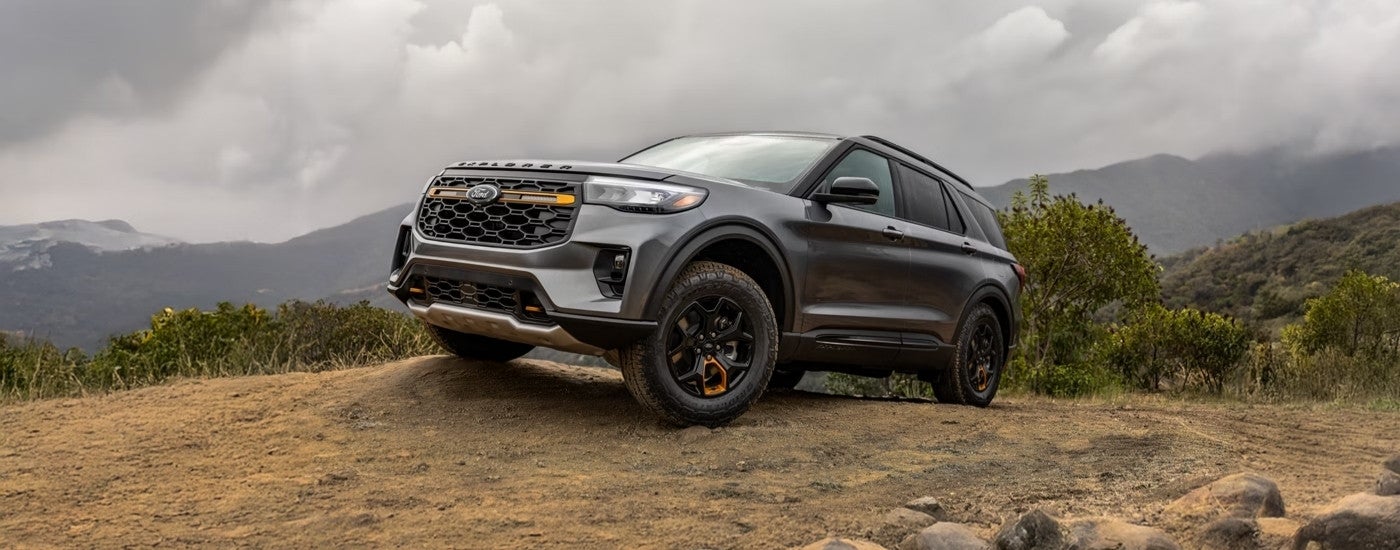 Black 2026 Ford Explorer Tremor parked off-road on a hill.