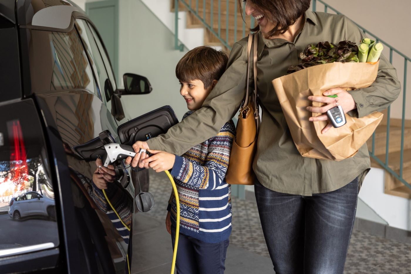 Mother and Son Plugging in a New Ford Electric Vehicle